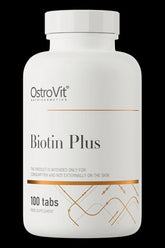 OstroVit Biotin Plus supplement bottle with 100 tabs, promoting healthy skin, hair, and nails.